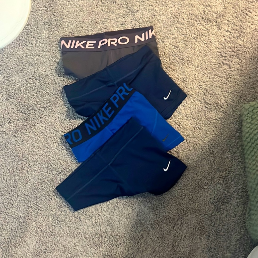 Set of Nike spandex, purple one is fraed a little bit at the bottom